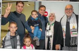 ?? ?? Home fRee: Ibrahim Alagha, centre, and his extended family at the airport
