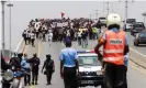  ?? Photograph: Osvaldo Silva/AFP/Getty ?? Police in Luanda watch a protest against the rising cost of living and corruption in Angola, one of the oil-producing states the report warns are vulnerable.