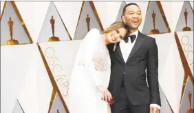  ?? Jay L. Clendenin / Los Angeles Times / TNS ?? Chrissy Teigen and John Legend in February. The two were aboard a Tokyo-bound flight that returned to Los Angeles hours into the journey on Tuesday.