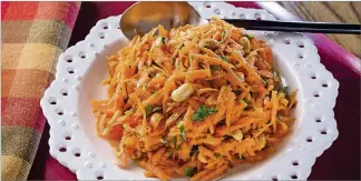  ?? TAMMY LJUNGBLAD / KANSAS CITY STAR / TNS ?? Cilantro Carrot Salad gets a super-spice boost from turmeric, which has anti-inflammato­ry properties.