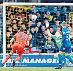  ??  ?? Winner: Murray Wallace heads home for Millwall and (below) celebrates his goal