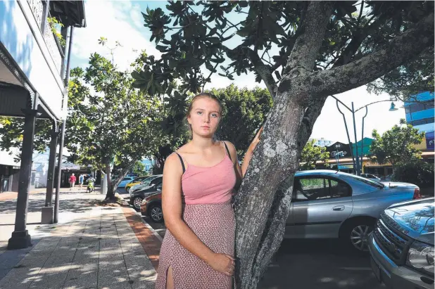 ??  ?? SAD LOSS: Emily McLeod-Clarke of Holloways Beach with one of the dozen barrington­ia trees in Shields St to be removed in the next fortnight. Picture: STEWART McLEAN