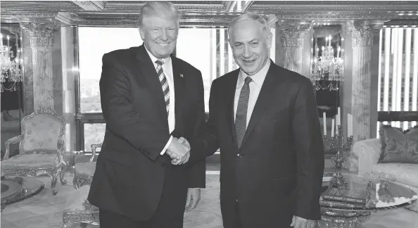  ?? KOBI GIDEON / GPO VIA THE ASSOCIATED PRESS FILES ?? Donald Trump shakes hands with Israeli Prime Minister Benjamin Netanyahu in September while Trump was campaignin­g for the U.S. presidency.