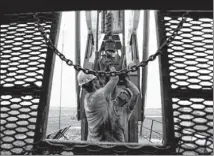  ?? GREGORY BULL / ASSOCIATED PRESS 2011 ?? Austin Mitchell (left) and Ryan Lehto work on an oil derrick outside of Williston, N.D. The U.S. is on pace to pass Saudi Arabia as the world’s top oil producer within two years.