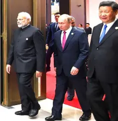  ??  ?? This handout photograph released by India’s Press Informatio­n Bureau (PIB) shows Indian Prime Minister Narendra Modi (left) arriving with Xi (right) and Putin to attend the restricted session of the SCO summit. — AFP photo