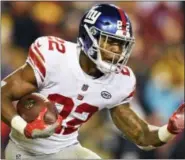  ?? NICK WASS — THE ASSOCIATED PRESS ?? New York Giants running back Wayne Gallman (22) carries the ball during the second half of an NFL football game against the Washington Redskins in Landover, Md., Thursday.