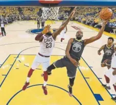  ?? Kyle Terada, Getty Images ?? Golden State Warriors forward Kevin Durant attempts a layup over LeBron James of the Cleveland Cavaliers during the second quarter Sunday night.