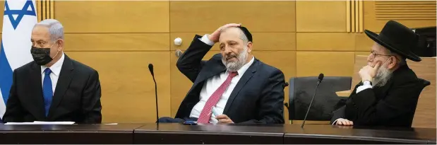  ?? (Yonatan Sindel/Flash90) ?? OPPOSITION LEADER Benjamin Netanyahu with Shas head Arye Deri and UTJ MK Ya’acov Litzman during a meeting with the opposition parties at the Knesset this week.