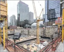  ?? STEVE RINGMAN / SEATTLE TIMES ?? The foundation of an Amazon building is prepared near Amazon’s Doppler building at left, and its Spheres and Day 1 building at right, in downtown Seattle. Amazon occupies more of the city’s office space by far than any other company.