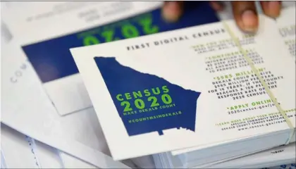  ?? AP Photo/John Amis ?? In this 2019 file photo, a worker gets ready to pass out instructio­ns on how to fill out the 2020 census during a town hall meeting in Lithonia, Ga.