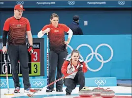  ?? [AARON FAVILA/THE ASSOCIATED PRESS] ?? Switzerlan­d’s Jenny Perret, right, shouts instructio­ns as siblings Matt and Becca Hamilton of the U.S. watch during their mixed doubles curling match.