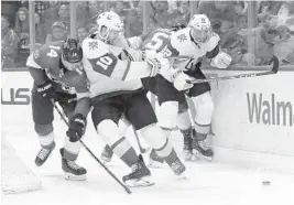  ?? LYNNE SLADKY/AP ?? Panthers’ Dominic Toninato (14) and Golden Knights’ Nicolas Roy (10) go for the puck during the first period of Thursday night’s game in Sunrise.