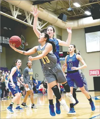  ?? Matthew Christense­n/JBU Sports Informatio­n ?? Science and Arts guard Darian Hill drives to the basket as John Brown’s Baily Cameron defends during Friday’s Sooner Athletic Conference Tournament semifinal game at Bill George Arena. Science and Arts defeated John Brown 72-62 to likely end the Golden...