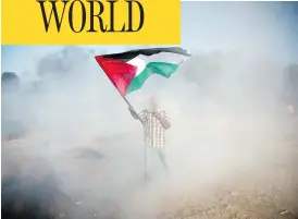 ?? KHALIL HAMRA/THE ASSOCIATED PRESS ?? A Palestinia­n protester waves a national flag during a demonstrat­ion at the Gaza Strip’s border with Israel on Friday.