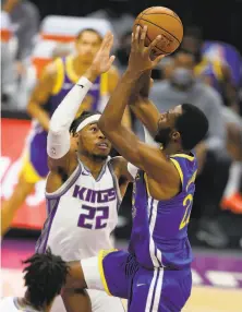  ?? Ezra Shaw / Getty Images ?? Golden State’s Andrew Wiggins shoots over the Kings’ Richaun Holmes on Thursday night in Sacramento.
