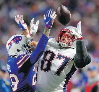  ?? JEFFREY BARNES, THE ASSOCIATED PRESS ?? Patriots tightend Rob Gronkowski hauls in a pass with Bills defensive back Phillip Gaines all over him during the second half on Monday night.