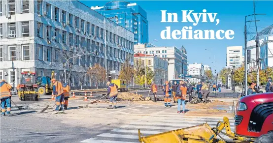  ?? Picture Patricia HuchotBois­sier ?? Work teams rush to repair the damage done by Russian missile strikes after the rush-hour attack on Kyiv