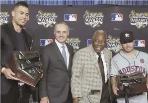  ?? AP PHOTO ?? TOPS IN THEIR FIELD: Giancarlo Stanton (left) of the Marlins and Jose Altuve (right) of the Astros pose yesterday after receiving the Hank Aaron Award. Joining them are MLB commission­er Rob Manfred and Aaron.