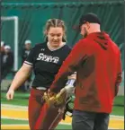  ?? Courtesy of VCSU ?? VCSU's head coach Matt Gable hands the ball off to incoming pitcher Maddy Zander earlier this season.