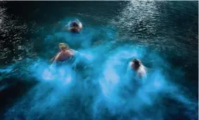  ?? LEE MCGRATH ?? People swimming in biolumines­cent plankton at Aberavon, Port Talbot