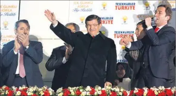  ?? European Pressphoto Agency ?? AT PARTY headquarte­rs in Ankara, Turkish Prime Minister Ahmet Davutoglu greets supporters. The Justice and Developmen­t Party received 49.4% of the vote, a 10-percentage-point increase compared with June.