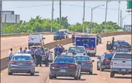  ?? LANDSBERGE­R/ THE OKLAHOMAN] ?? Crews work the scene of a fatal officer-involved shooting on Interstate 35 in Oklahoma City on Monday. [CHRIS