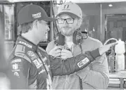  ?? Mel Evans / Associated Press ?? Dale Earnhardt Jr., right, shares a moment with Jeff Gordon, his substitute driver, in the Hendrick Motorsport­s garage at Dover Internatio­nal Speedway.