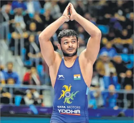  ??  ?? Deepak Punia acknowledg­es the crowd after beating Switzerlan­d’s Stefan Reichmuth 8-2 in the 86kg semi-finals at the World Wrestling Championsh­ips on Saturday.
AGENCIES