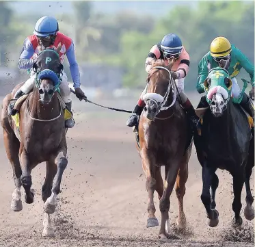  ?? FILE ?? SIR BUDGET (centre) in action against ANOTHER BULLET (left) and ARMAGEDDON (right) at Caymanas Park on May 12.