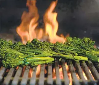  ?? ALEJANDRO TAMAYO U-T PHOTOS ?? Broccolini is cooked on the grill after being tossed with vegetable oil and a little salt and pepper. When the broccolini is a little charred, remove it from the heat.