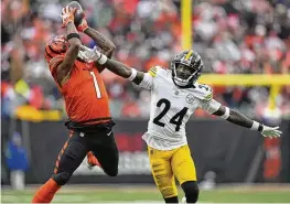  ?? CAROLYN KASTER / AP ?? Cincinnati Bengals wide receiver Ja’marr Chase (1) catches a pass from quarterbac­k Jake Browning for a first down with Pittsburgh Steelers cornerback Joey Porter Jr. (24) defending during the second half of an NFL football game in Cincinnati, Sunday, Nov. 26, 2023.