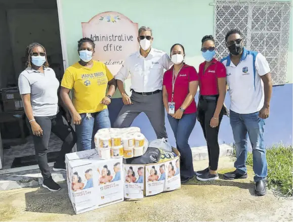  ?? ?? West Haven Children’s Home’s administra­tive assistant Sadie Brissett-ellis (left) and Fayonna Boothe (second left), special education teacher receive some of the donated items from representa­tives of Sandals Resorts Internatio­nal (from third left) Jeremy Jones, director of government affairs and corporate compliance; Connie Chin, corporate compliance administra­tor; Tasha-gaye Davis, executive assistant; and Crissano Dalley, public relations manager.