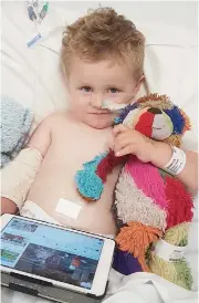  ??  ?? Three-year-old Ashton Honeyman of Drouin, currently in hospital recovering from a ruptured appendix, is reunited with his beloved “Charlie Bear” after the efforts of Warragul Linen Service.