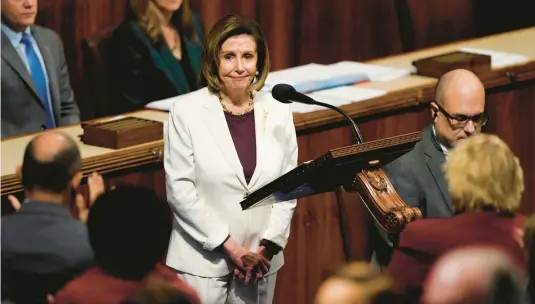  ?? CAROLYN KASTER/AP ?? Lawmakers stand and applaud Thursday as House Speaker Nancy Pelosi speaks on the House floor at the Capitol in Washington, D.C.