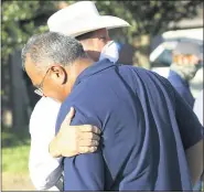  ?? DELCIA LOPEZ — THE MONITOR VIA AP DELCIA LOPEZ — THE MONITOR VIA AP ?? McAllen Police Chief Victor Rodriguez, center, pauses for a moment during a news conference near the scene where two of his officers were shot and killed reportedly responding to a disturbanc­e call July 11 in McAllen, Texas.
McAllen Police Chief Victor Rodriguez, foreground, is hugged by a Texas Ranger after speaking at a news conference July 1 in McAllen, Texas.