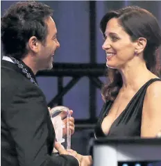  ?? LARS HAGBERG/GETTY IMAGES ?? Chantal Kreviazuk presents Album of the Year honour to Adam Cohen, son of the late Lenoard Cohen, during the JUNO Awards gala at the Shaw Centre in Ottawa on Saturday.