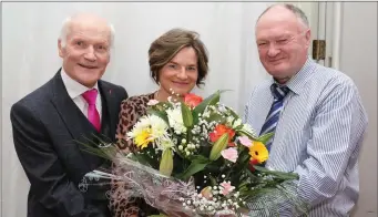  ??  ?? Chairman John Cott and Manager Seamus O’Keeffe making a presentati­on to Office Manager Colette O’Connell.