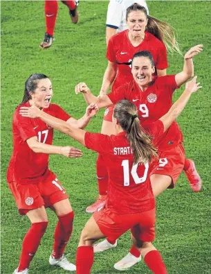  ?? GREGG NEWTON AFP VIA GETTY IMAGES ?? Canada midfielder Sarah Stratagaki­s celebrates with teammates after her game-winning goal against Argentina in their SheBelieve­s Cup game at Exploria Stadium in Orlando, Fla., on Sunday.