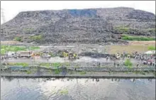  ?? PTI FILE ?? A massive chunk of Delhi’s Ghazipur landfill fell into a canal running alongside on September 1, killing two people and washing away four vehicles on the adjoining road.