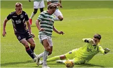  ??  ?? Action man: Ross Doohan saves at the feet of James Forrest