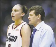  ?? Andy Lyons / Getty Images ?? UConn coach Geno Auriemma talks with Diana Taurasi during the NCAA Tournament championsh­ip game against Oklahoma in March 2002.