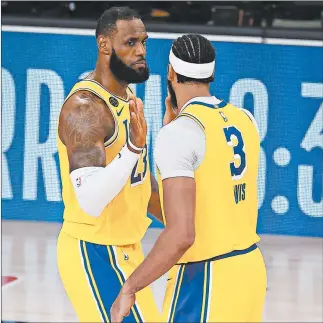  ?? MIKE EHRMANN/GETTY ?? LeBron James and Anthony Davis react after the Lakers’ win Thursday night.