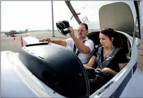  ?? Arkansas Democrat-Gazette/THOMAS METTHE ?? Flight instructor Jeff Harless (left) and student Grace Harrison, 19, finish pre-flights checks before a training flight Thursday at Central Flying Service. A ceremony Wednesday will mark 475,000 flight training hours completed by Central Flying...