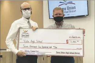  ?? LOANED PHOTO ?? YUMA UNION HIGH SCHOOL DISTRICT governing board President Phil Townsend (right) presents a school safety committee award in the amount of $7,200 to Vista High School Principal Brett Surguine for Vista’s ranking as the district’s top safety committee for 2020.