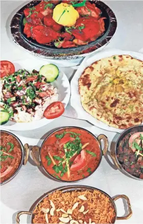  ?? ANGELA PETERSON / MILWAUKEE JOURNAL SENTINEL ?? Durbar offers a broad array of Indian dishes including tandoori chicken (from top, clockwise), masala kulcha bread, okra bhindi masala, Durbar special rice made with goat curry, baigan bharta and dahi papri chaat. In the center is lamb masala.