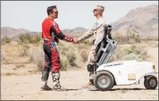  ?? SCOTT SHEW/COURTESY PHOTOGRAPH ?? John Hodel, founder of Stand for Vets, shakes hands with U.S. Army Staff Sgt. Odin Ayala.