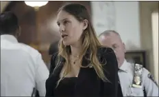  ?? ?? A woman is escorted from the courtroom during the fraud trial of former President Donald Trump on Wednesday at New York Supreme Court in New York. The woman, later identified as a court employee, was arrested Wednesday after she stood up at former Trump’s trial and walked toward the front of the courtroom where he was sitting.