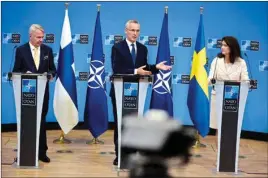  ?? PTI ?? Finland's Foreign Minister Pekka Haavisto, left, Sweden's Foreign Minister Ann Linde, right, and NATO Secretary General Jens Stoltenber­g attend a media conference after the signature of the NATO Accession Protocols for Finland and Sweden in the NATO headquarte­rs in Brussels, Tuesday