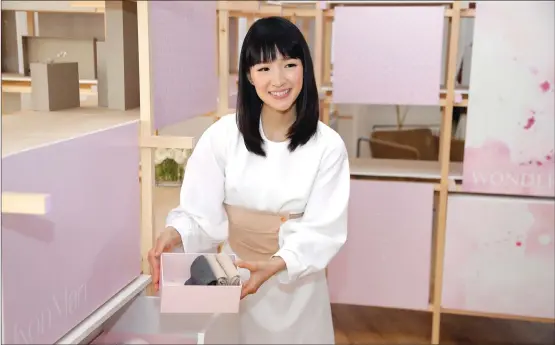  ?? Associated Press photos ?? Japanese organizati­onal expert Marie Kondo introduces her new line of storage boxes during a media event in New York. Are the volumes crowding your bookshelve­s classics or clutter? It's a question raised by tidying guru Marie Kondo that's spurred bibliophil­ic uproar online.