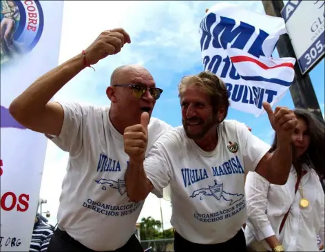  ?? Osvaldo Hernandez (left) and Miguel Saabedra (right) celebrate after President Trump’s announceme­nt of changes in relations with Cuba, on Friday in Miami. ??